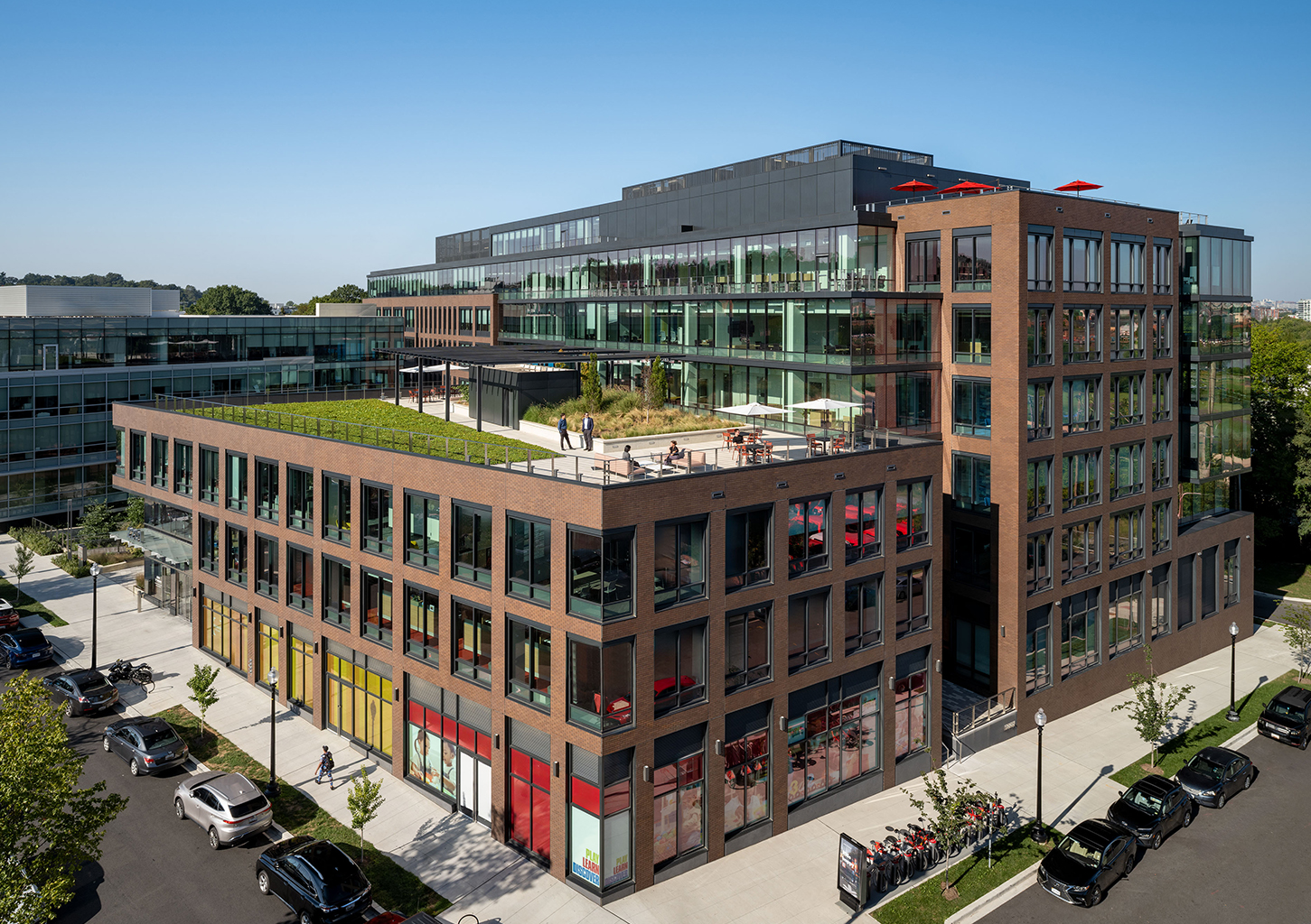 Modern buildings with green rooftops.